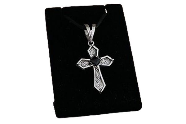 A black card with a cross pendant on it