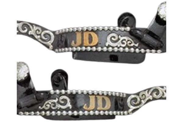 A pair of spurs with the letters jd on them