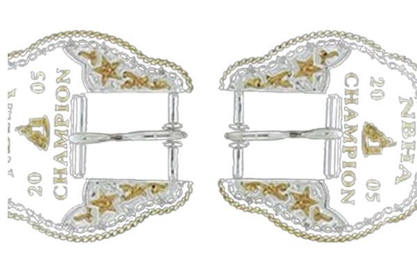 A pair of silver and gold buckles with the words champion on them
