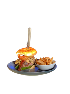A hamburger and french fries on a plate with a fork.