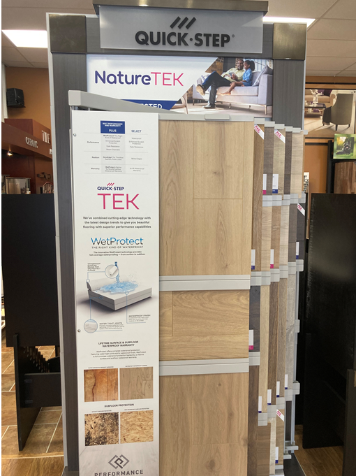 A display of quick step nature tek flooring in a store