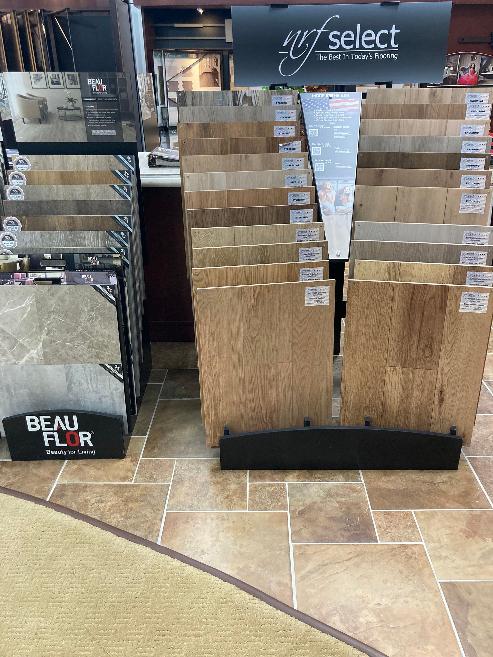 A display of wood flooring in a store with a sign that says select