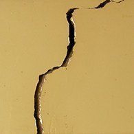 Crack in a yellow wall.