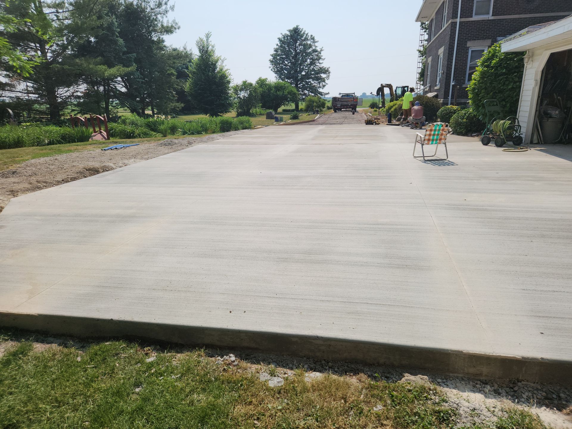 a concrete driveway is being built in front of a house .