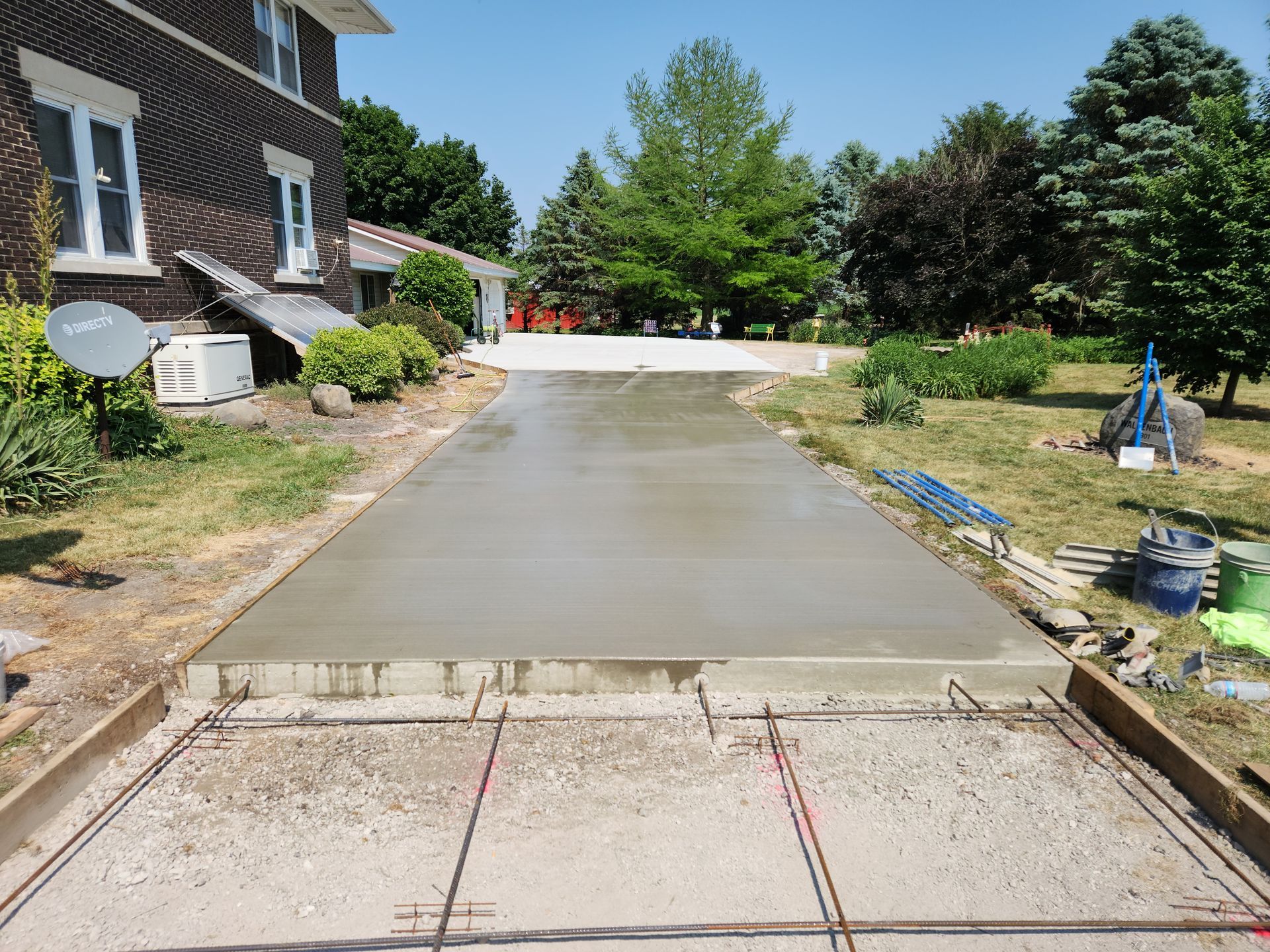 a concrete driveway is being built in front of a house .