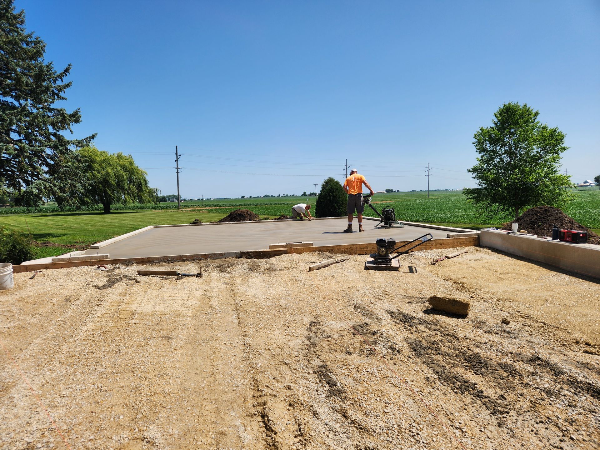 A man is standing on top of a dirt field.
