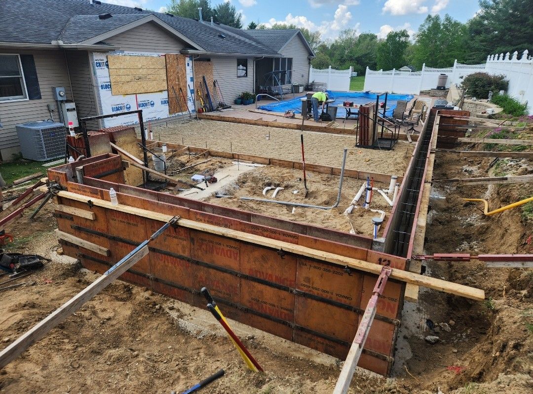 A house is being built with a pool in the backyard.