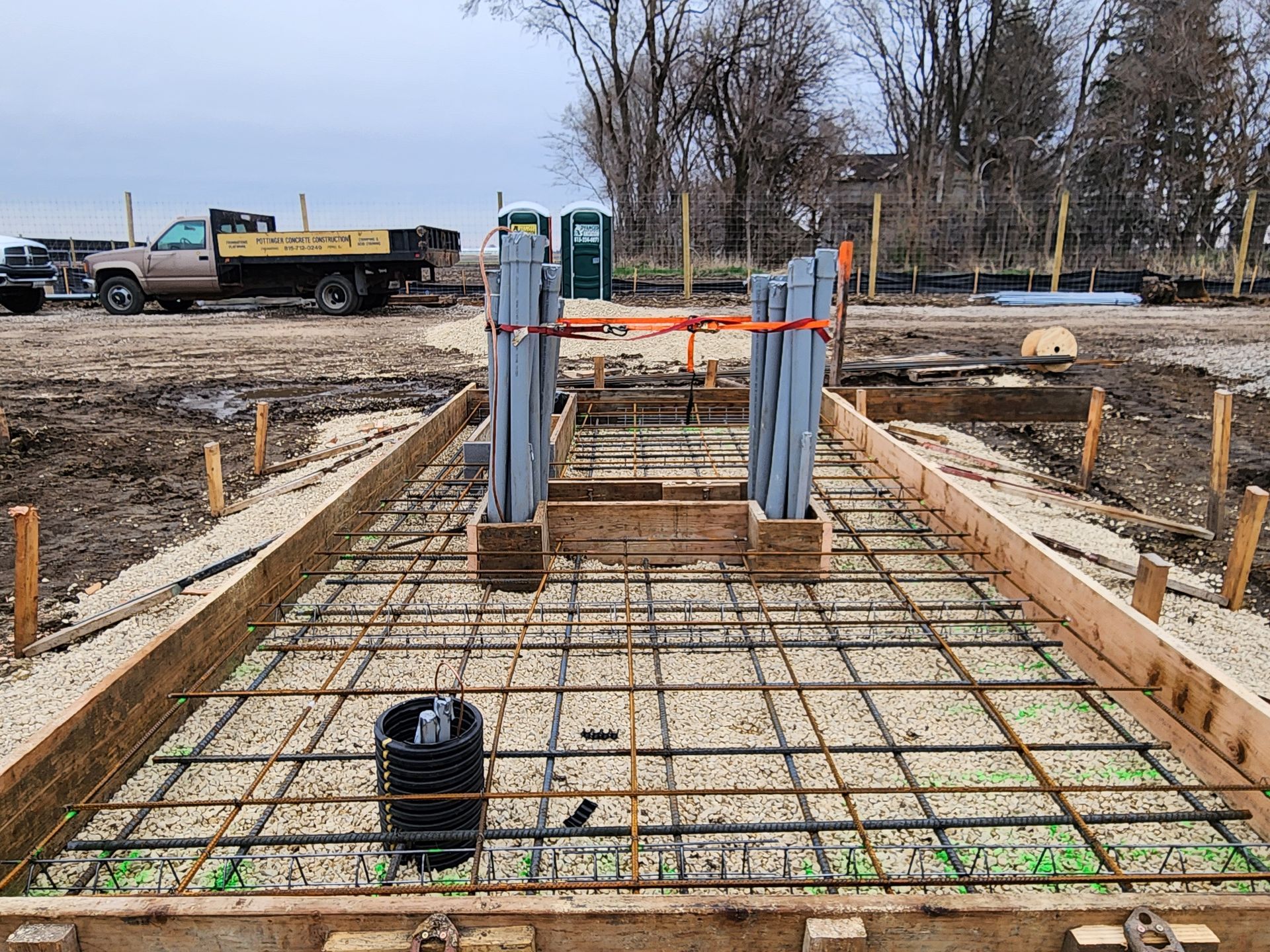 A construction site with a truck parked in the background.