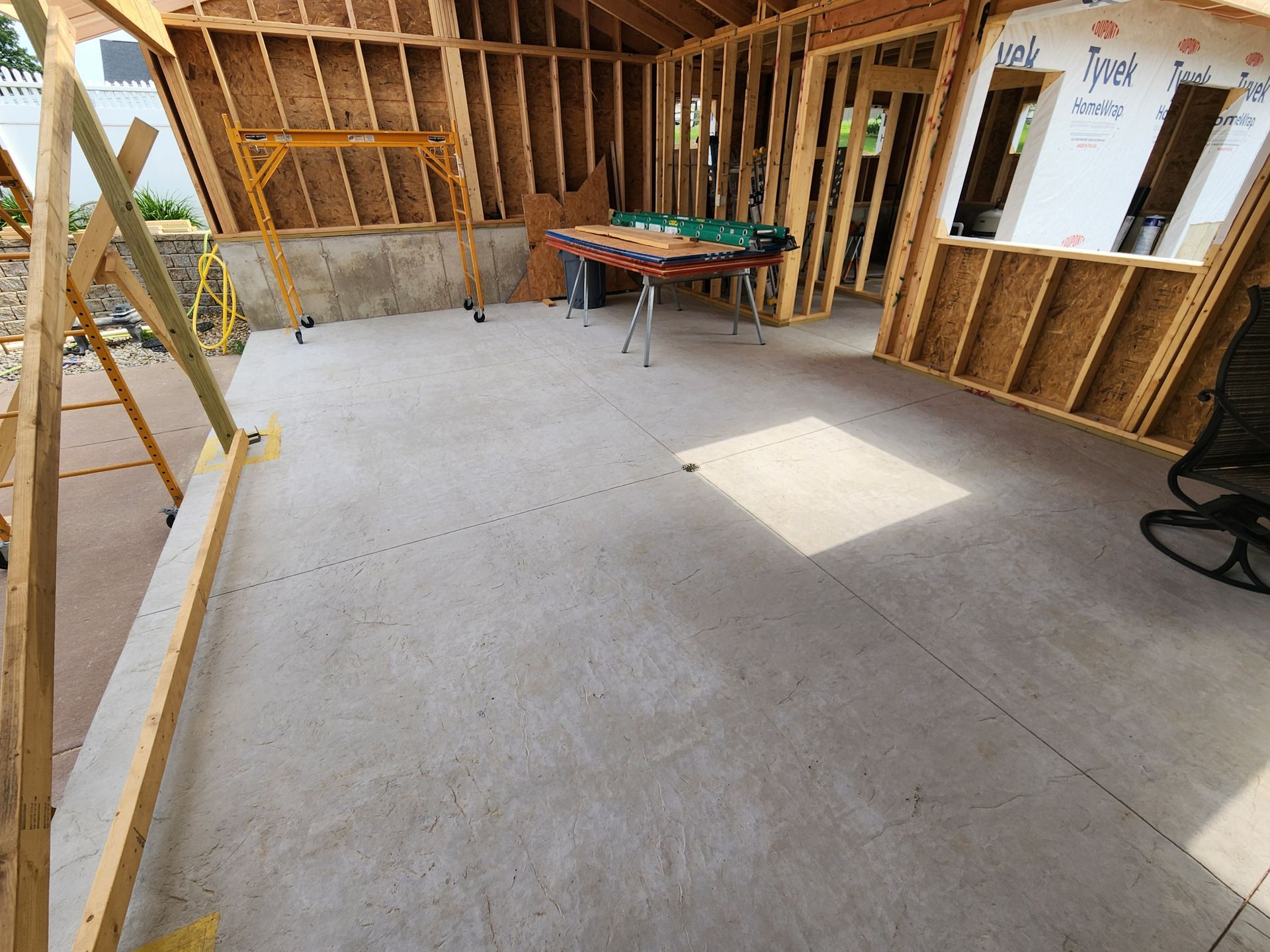 A room under construction with a table and chairs