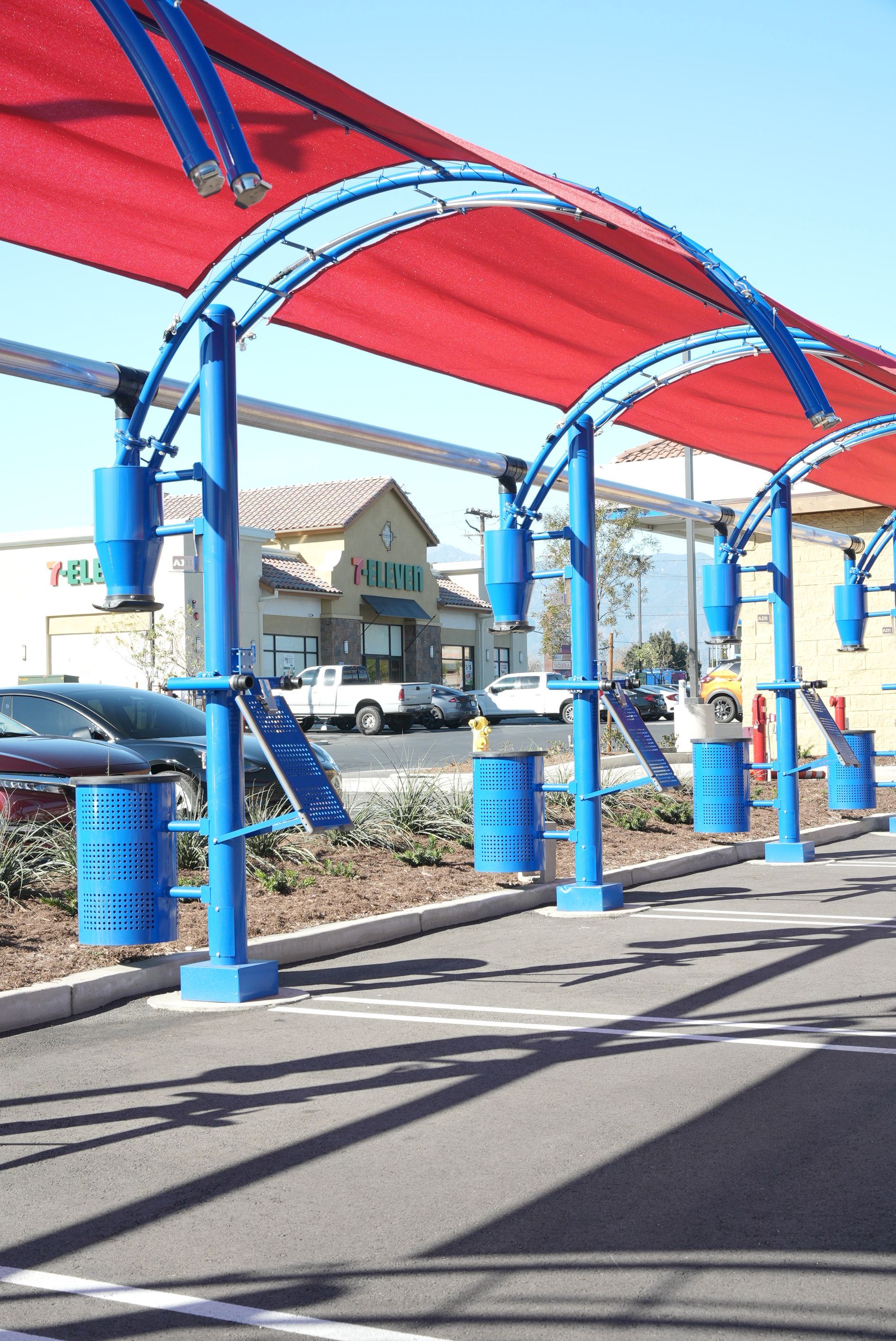 A row of blue and red umbrellas in a parking lot