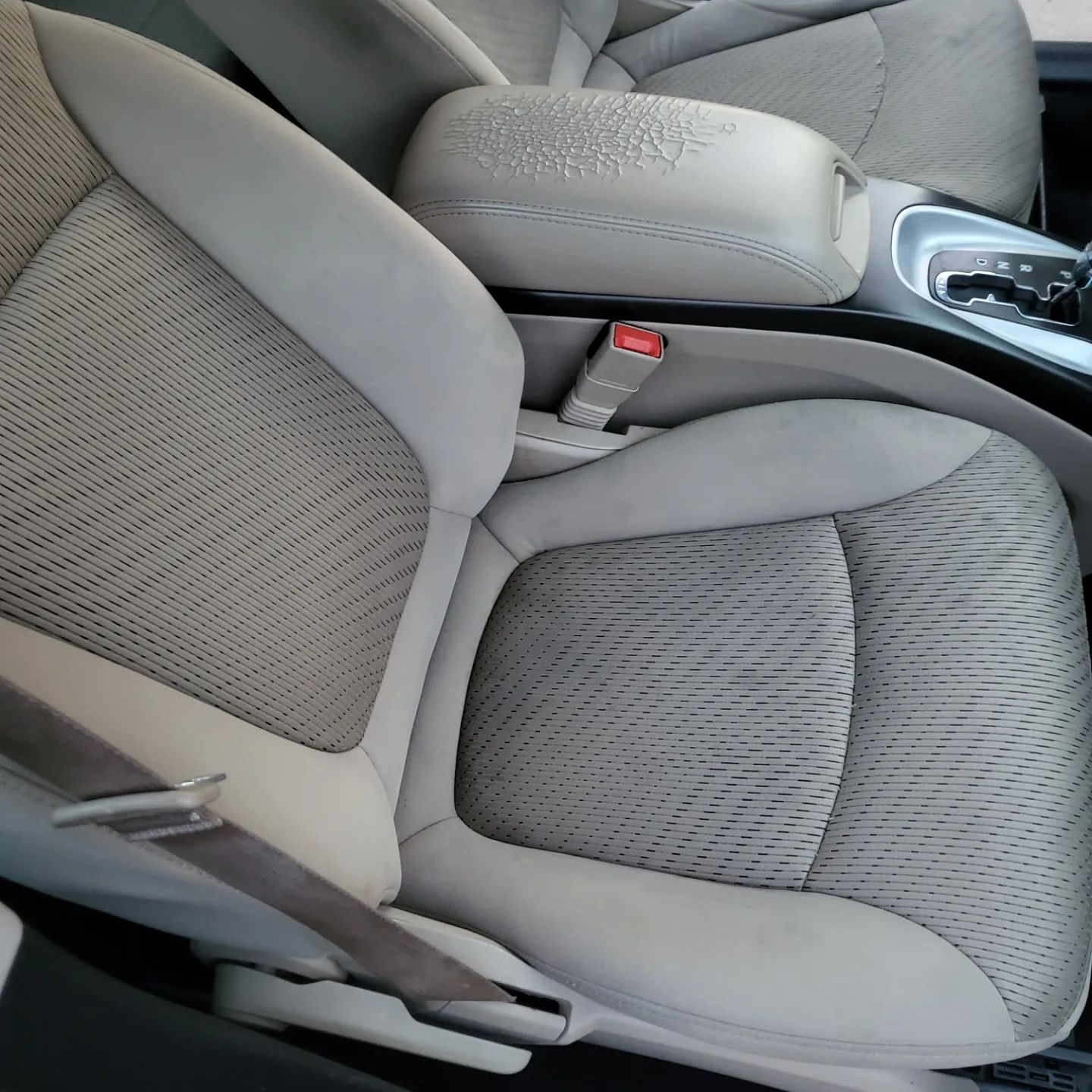 A car seat with a seat belt on it