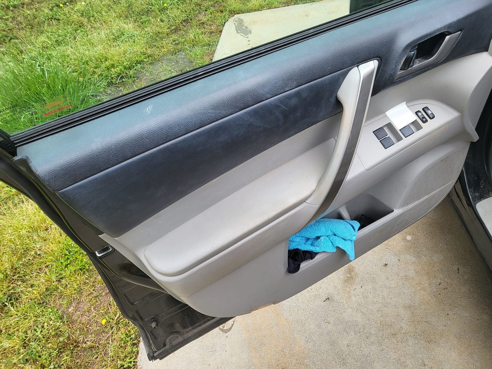 A car door with a blue glove in it