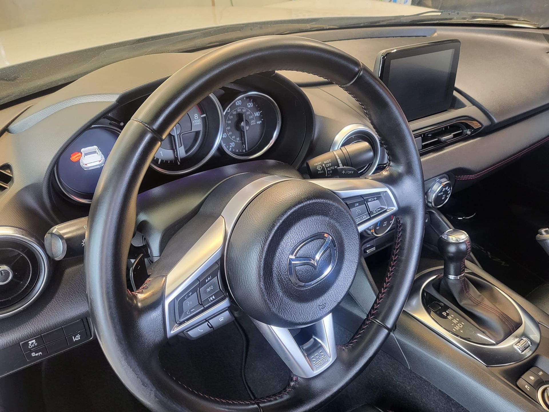 A close up of a steering wheel in a car