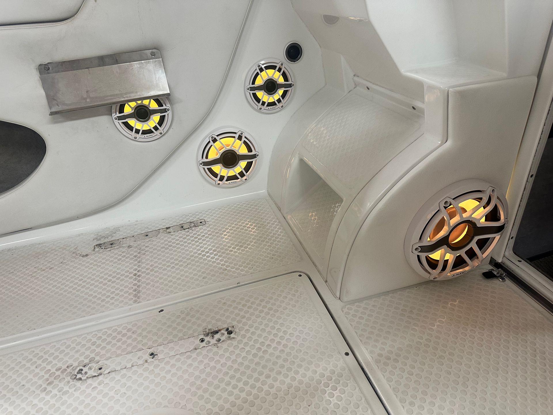 White boat interior with glowing yellow speakers.