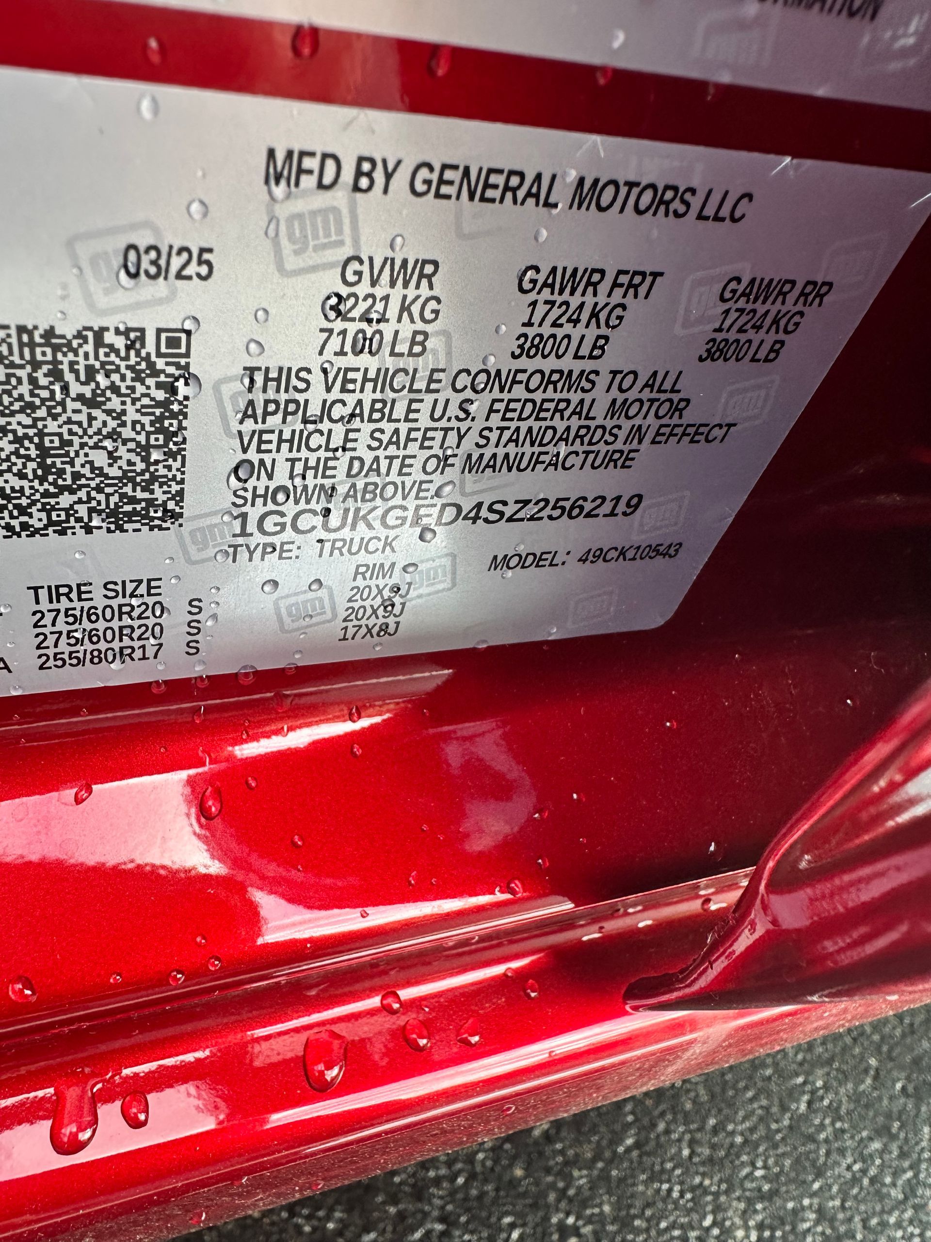 Red vehicle sticker with text, including GVWR, GAWR, and the VIN.