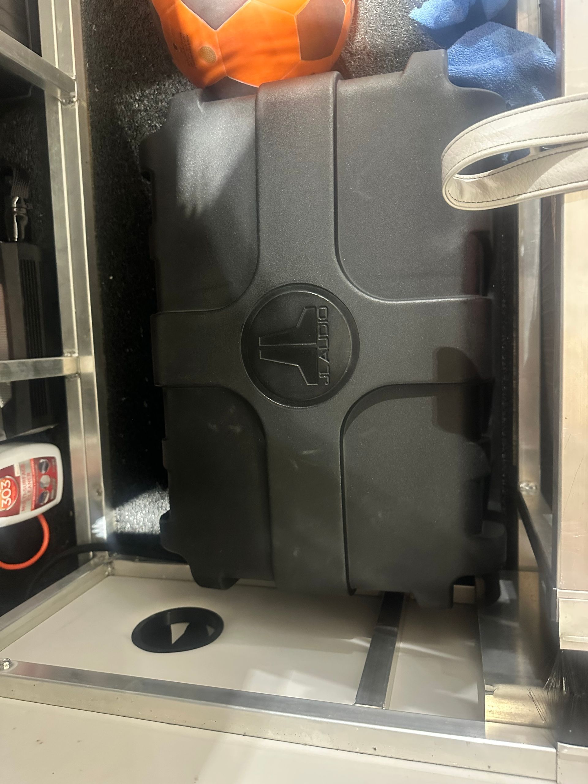 Black plastic equipment box with a logo in a compartment.