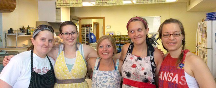 five women in a bake shop
