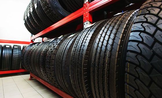 A bunch of tires are stacked on top of each other on a rack.