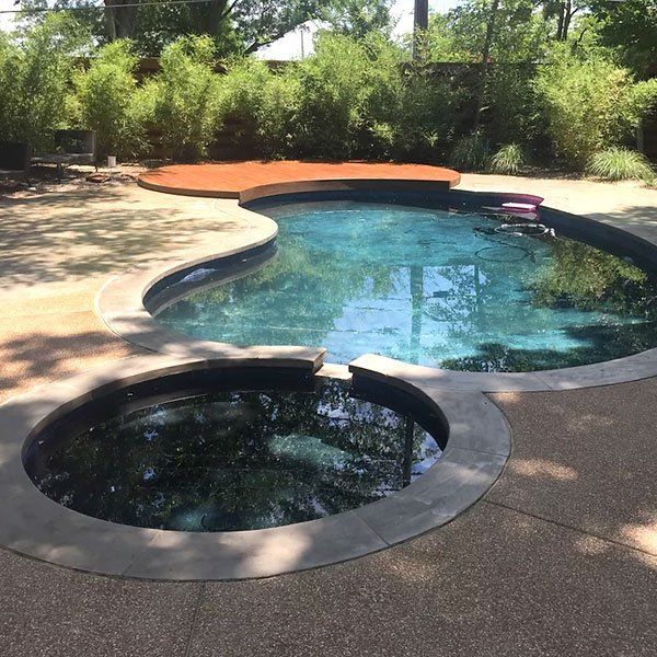 A large swimming pool with a smaller pool in the middle