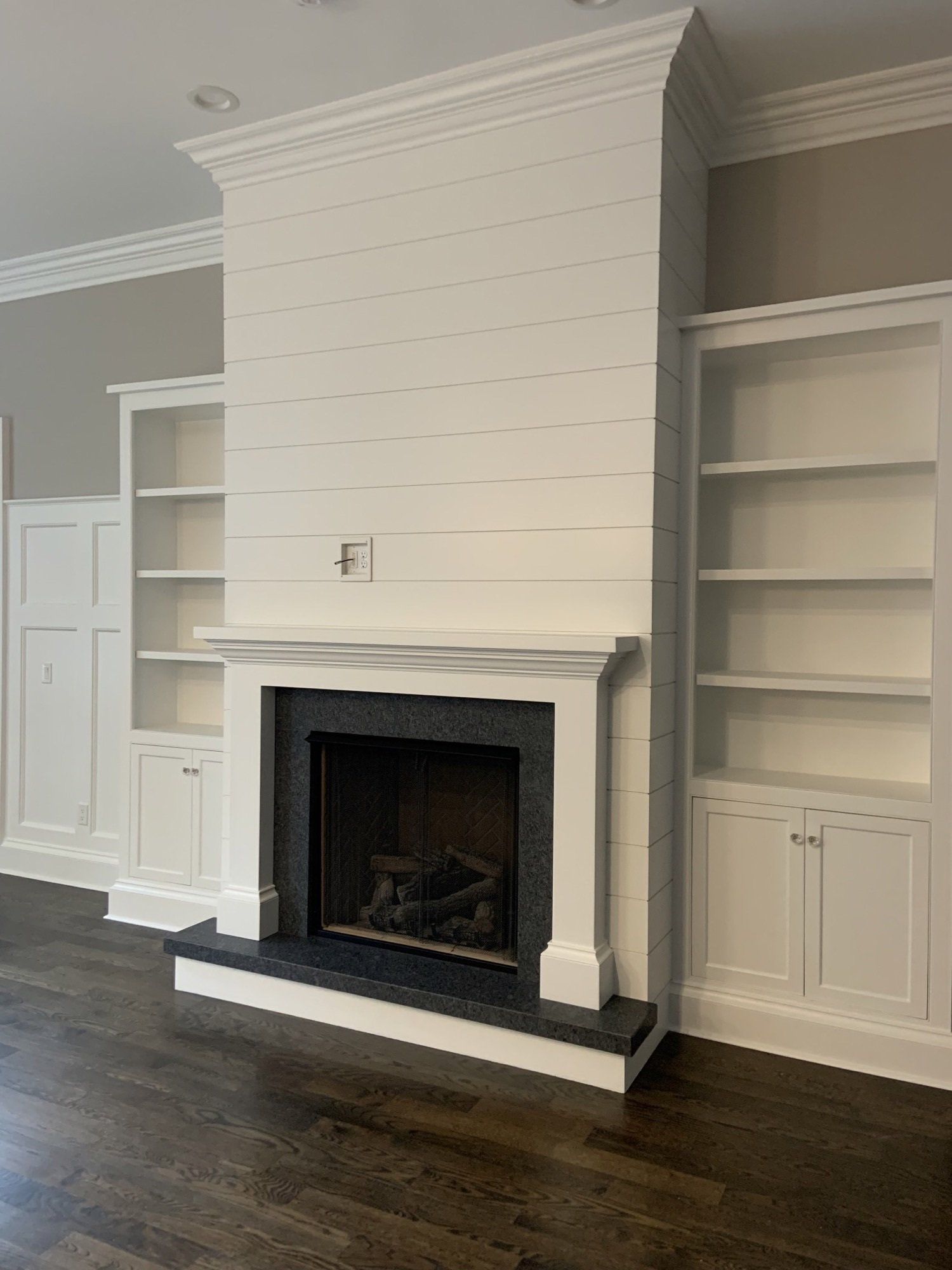 white wall and black fireplace