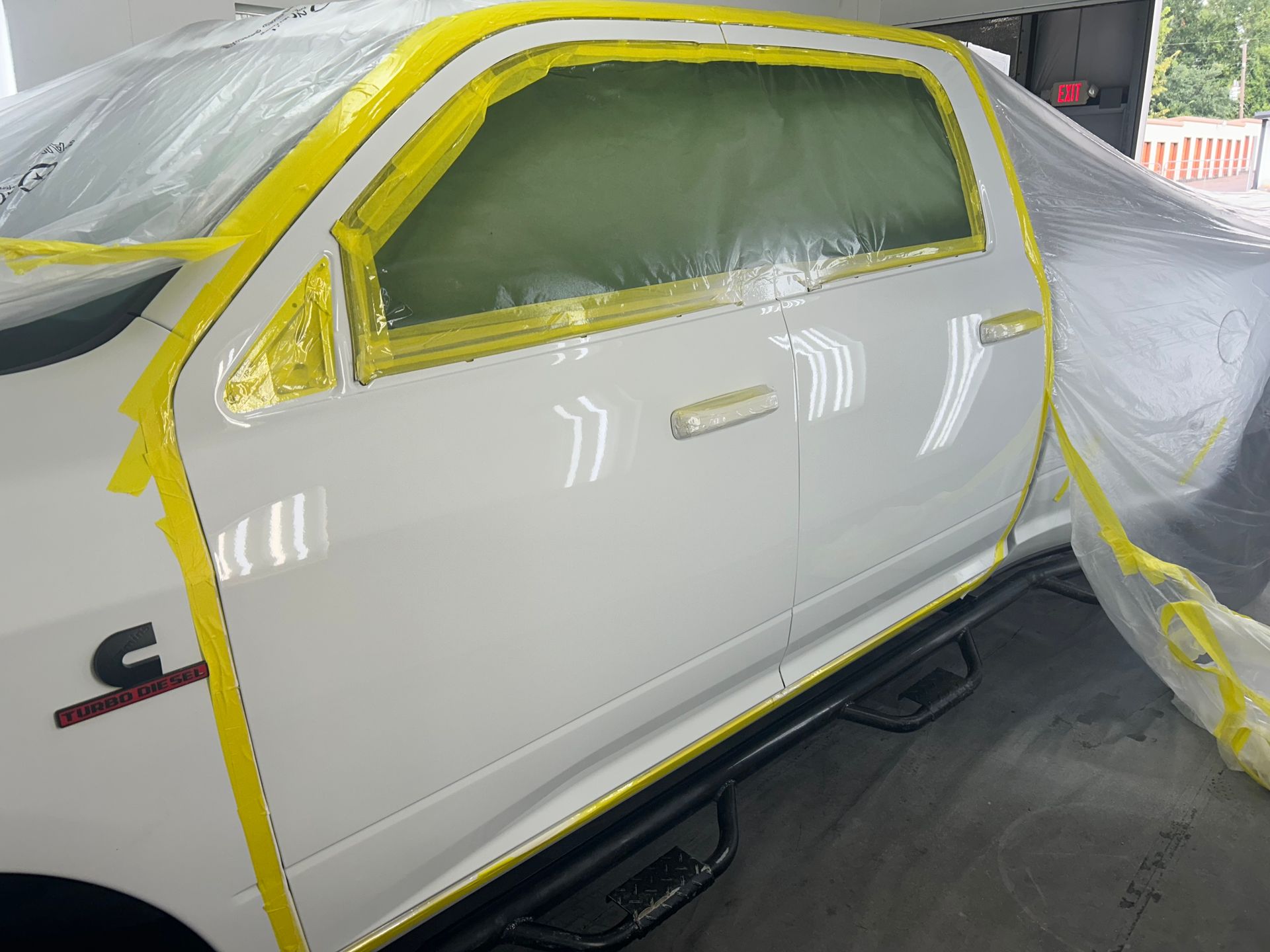 White truck door taped for paintwork.