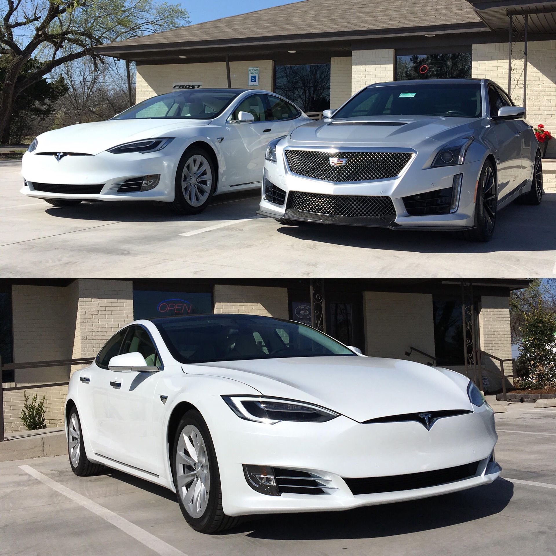 White Tesla and silver Cadillac parked outside a building.