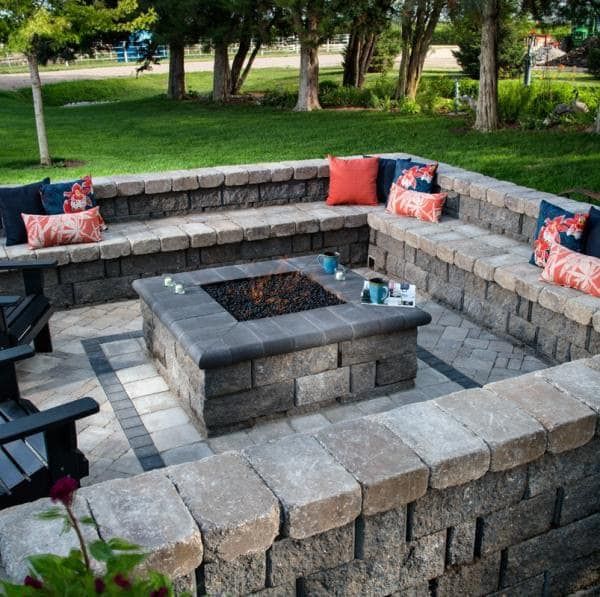 A fire pit sits in the middle of a brick patio