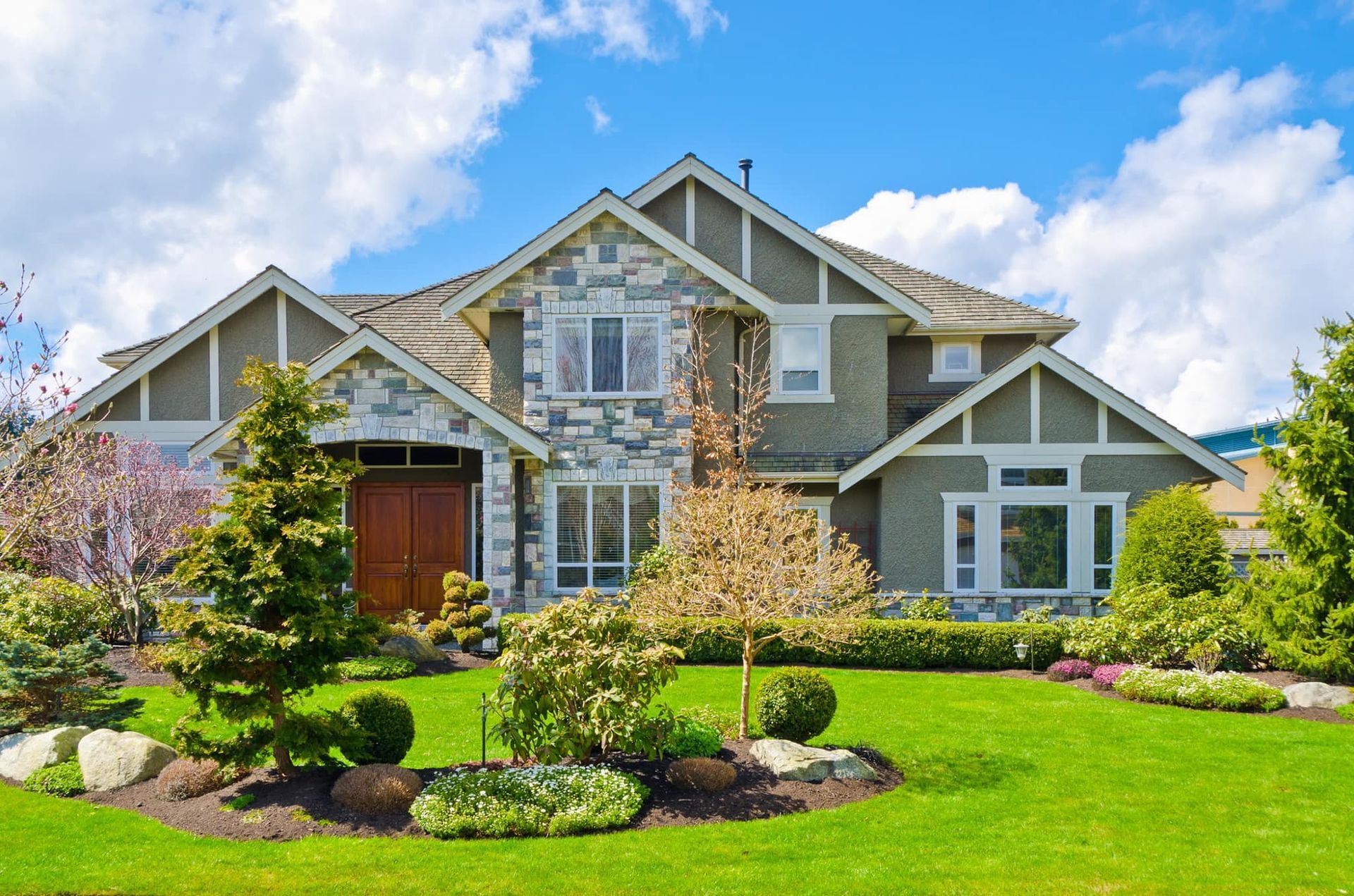 A large house with a lush green lawn in front of it