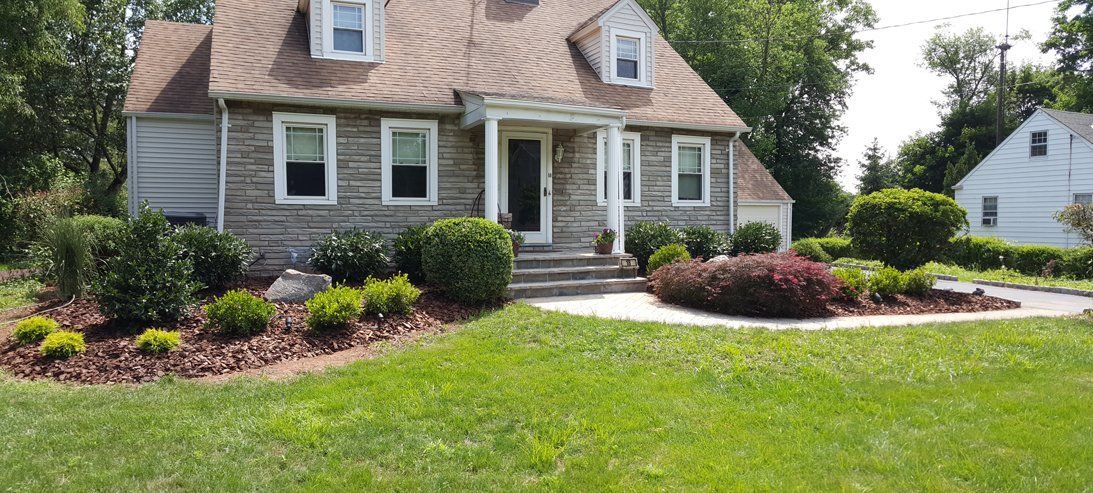 A large house with a lush green lawn in front of it.