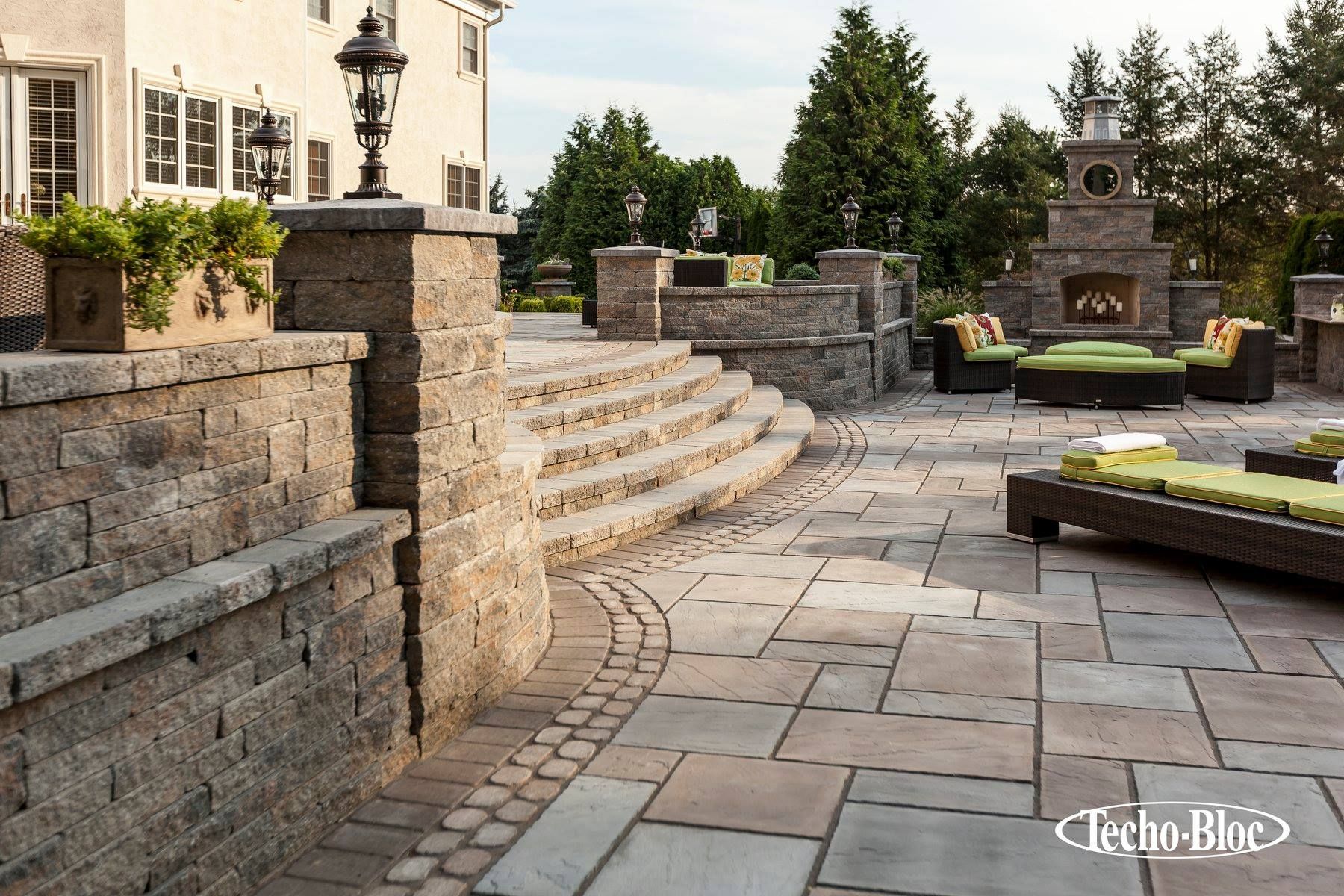 A large patio with a fireplace and stairs