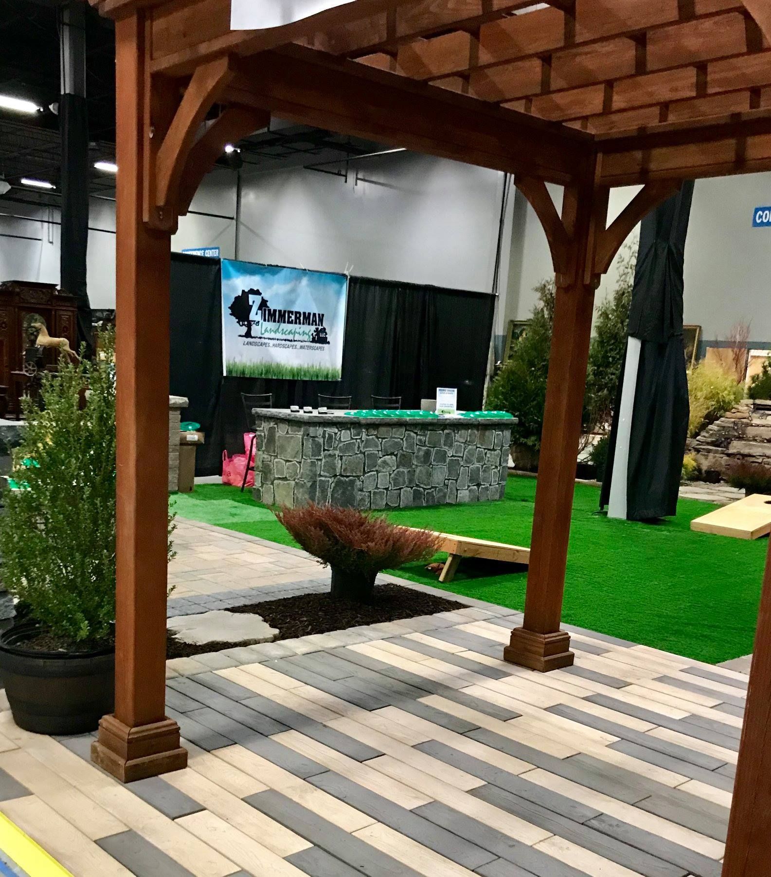 A wooden pergola is sitting on top of a brick patio.