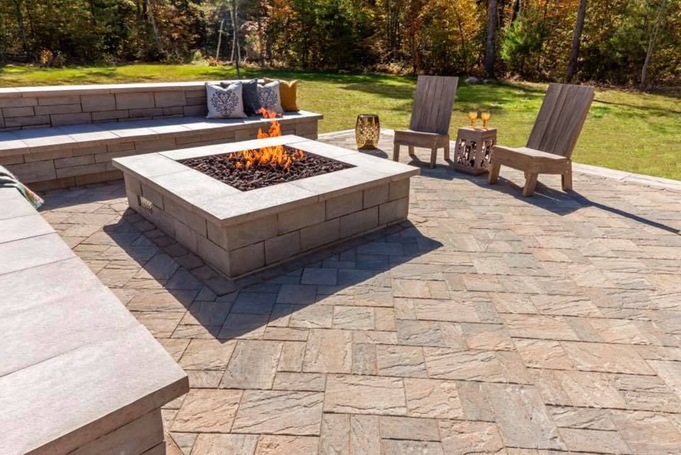 There is a fire pit in the middle of the patio.