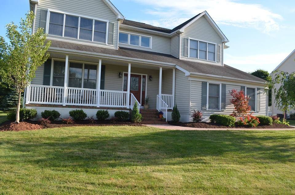 A large house with a large porch and lots of windows