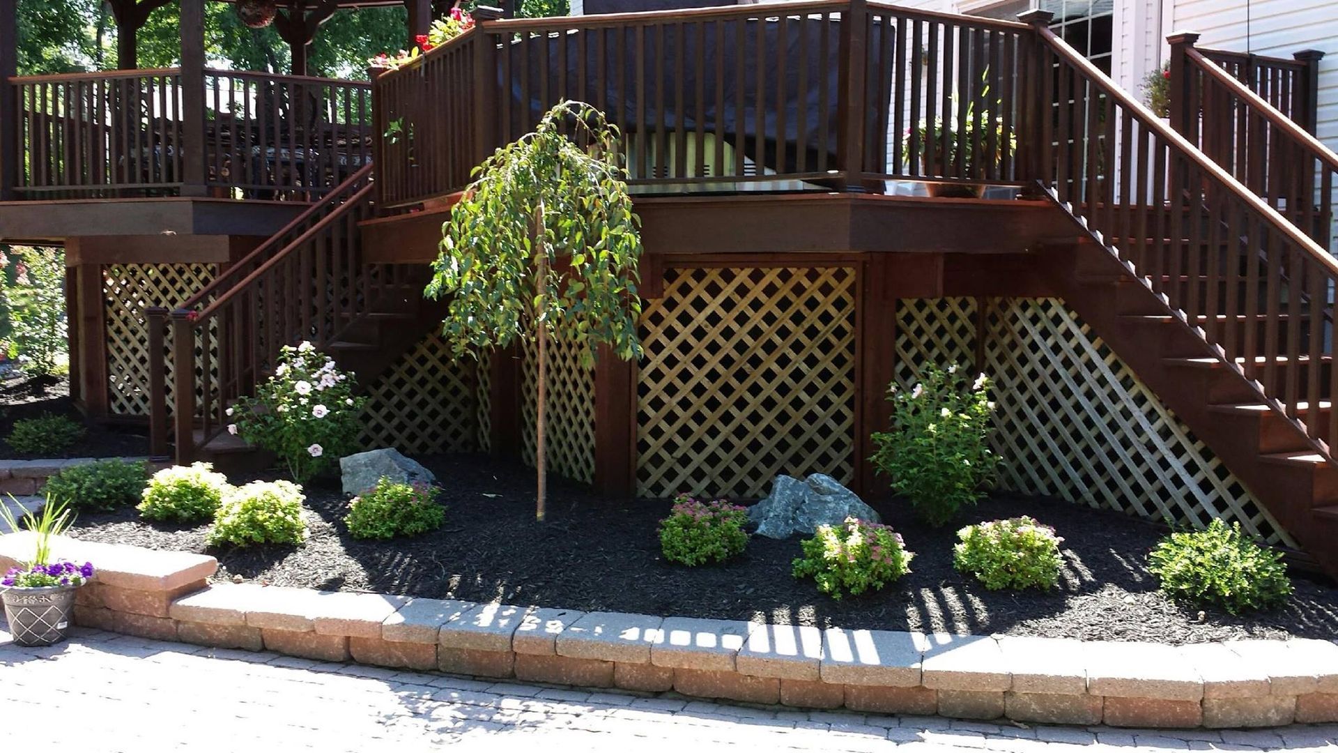 A wooden deck with stairs leading up to it