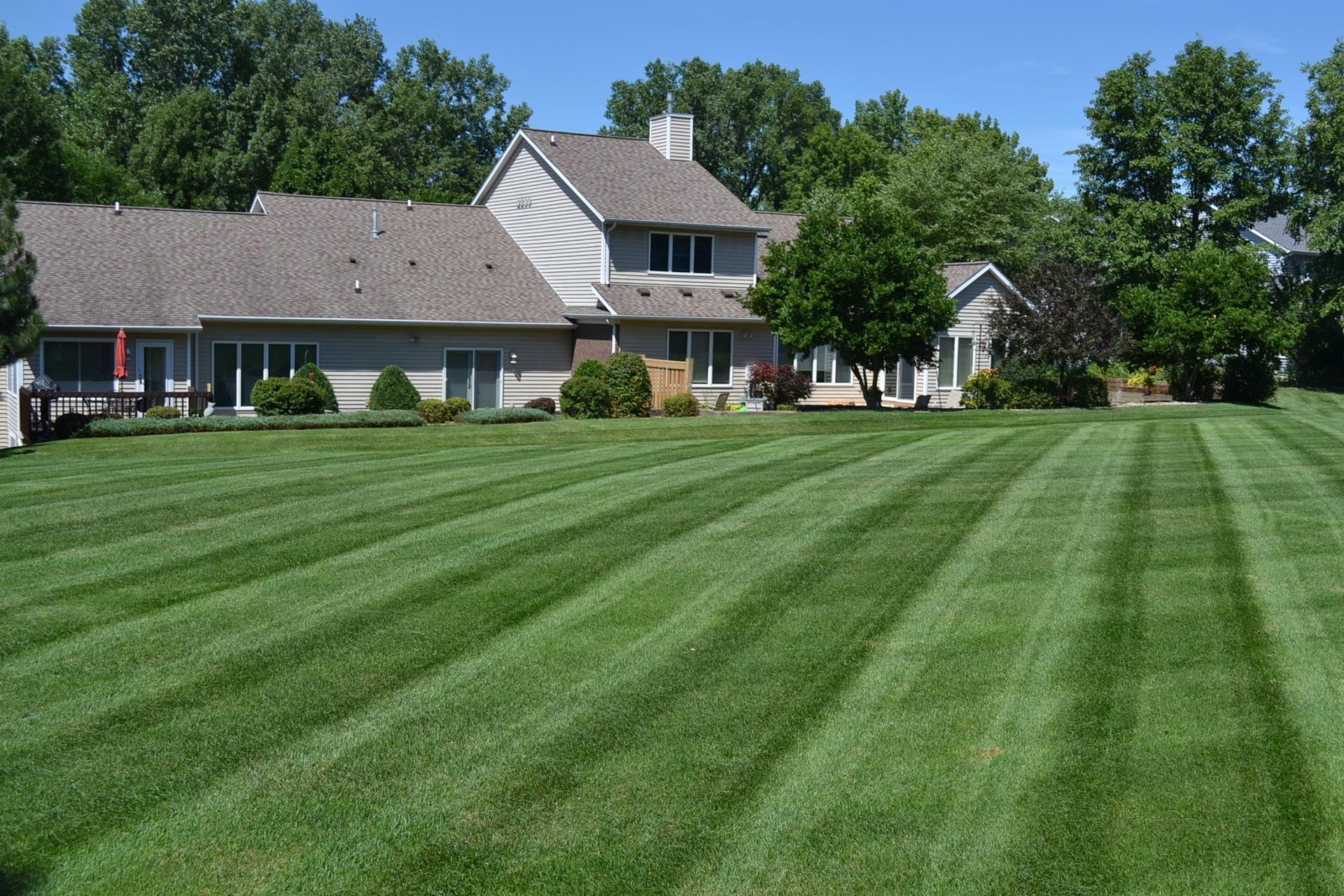 A large house with a lush green lawn in front of it.