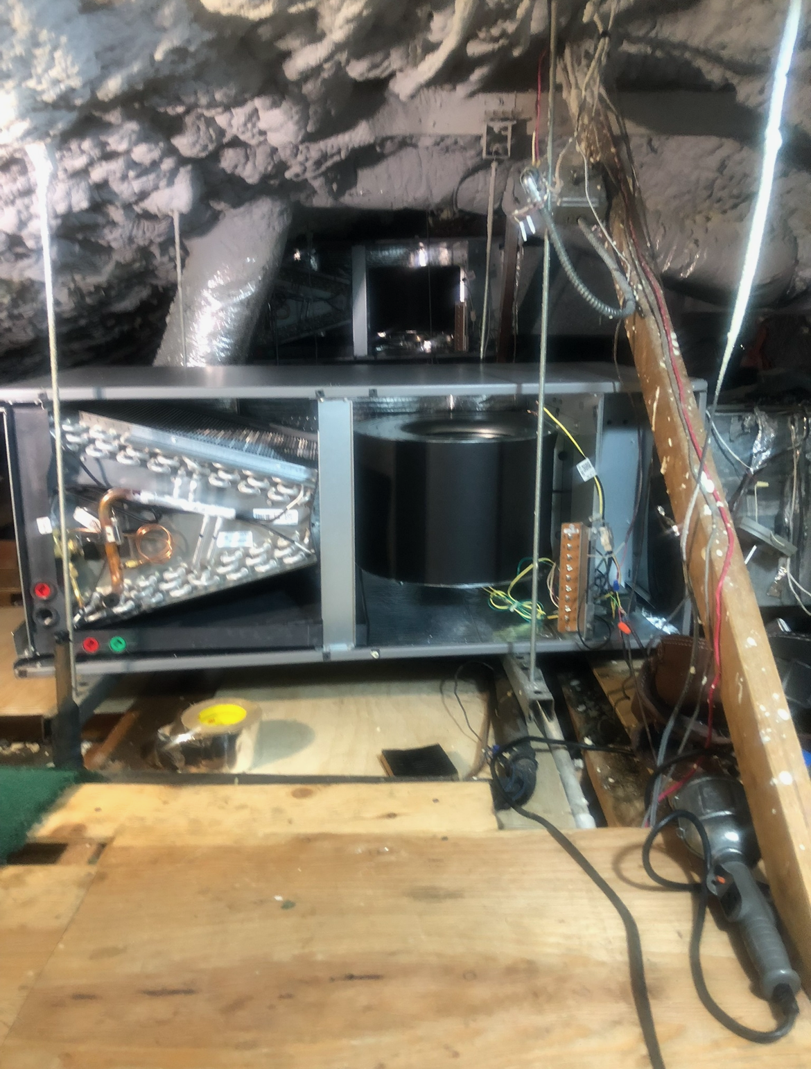 A ceiling fan is sitting on top of a wooden table.