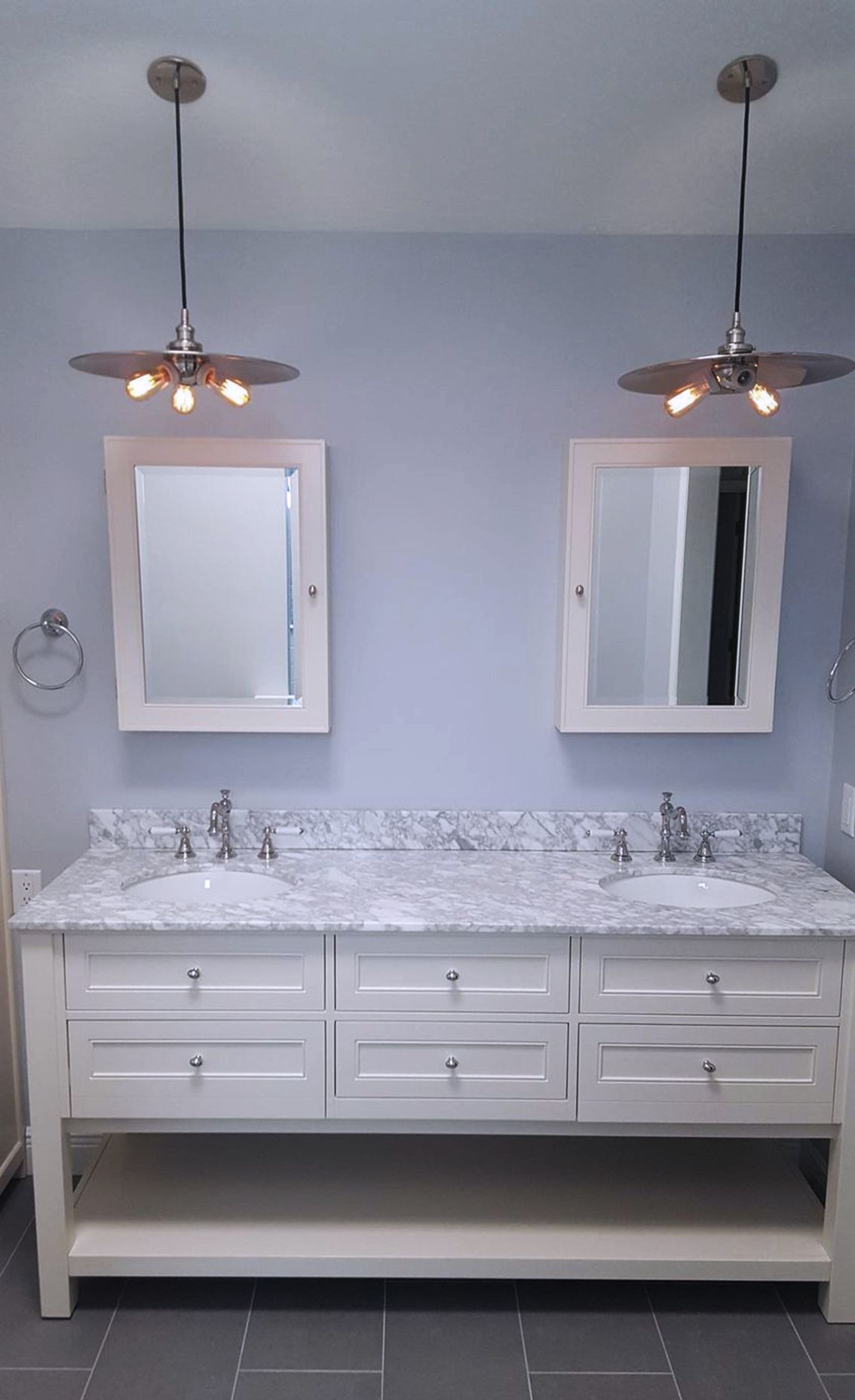 A bathroom with two sinks and two mirrors