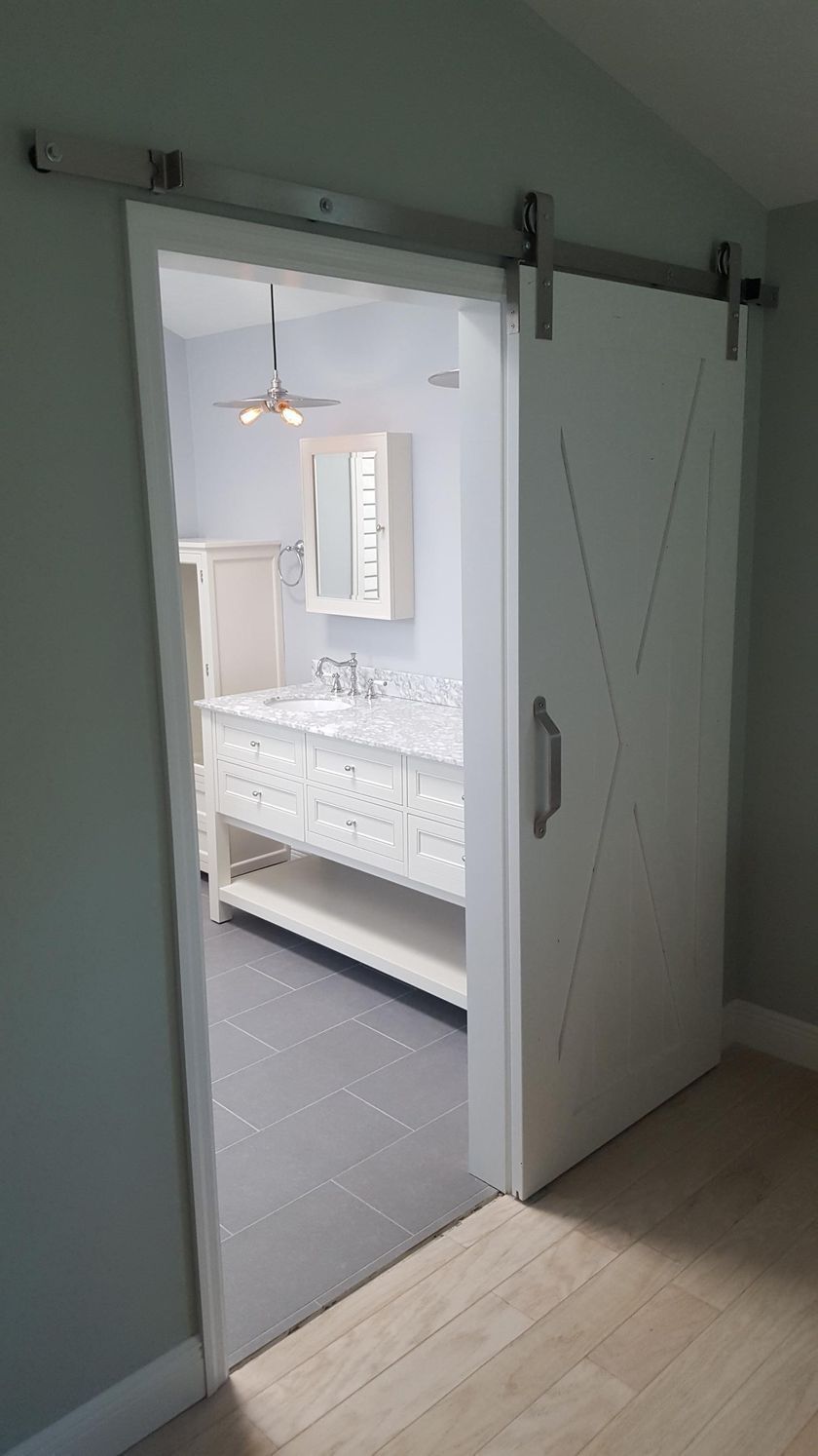 A bathroom with a sliding barn door