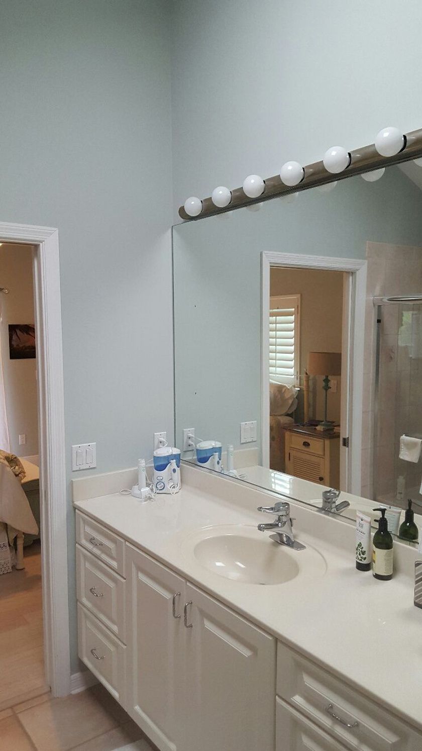 Bathroom with a sink and a large mirror