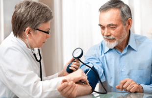Doctor measuring blood pressure of male patient