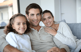 Cheerful family of three relaxing in sofa