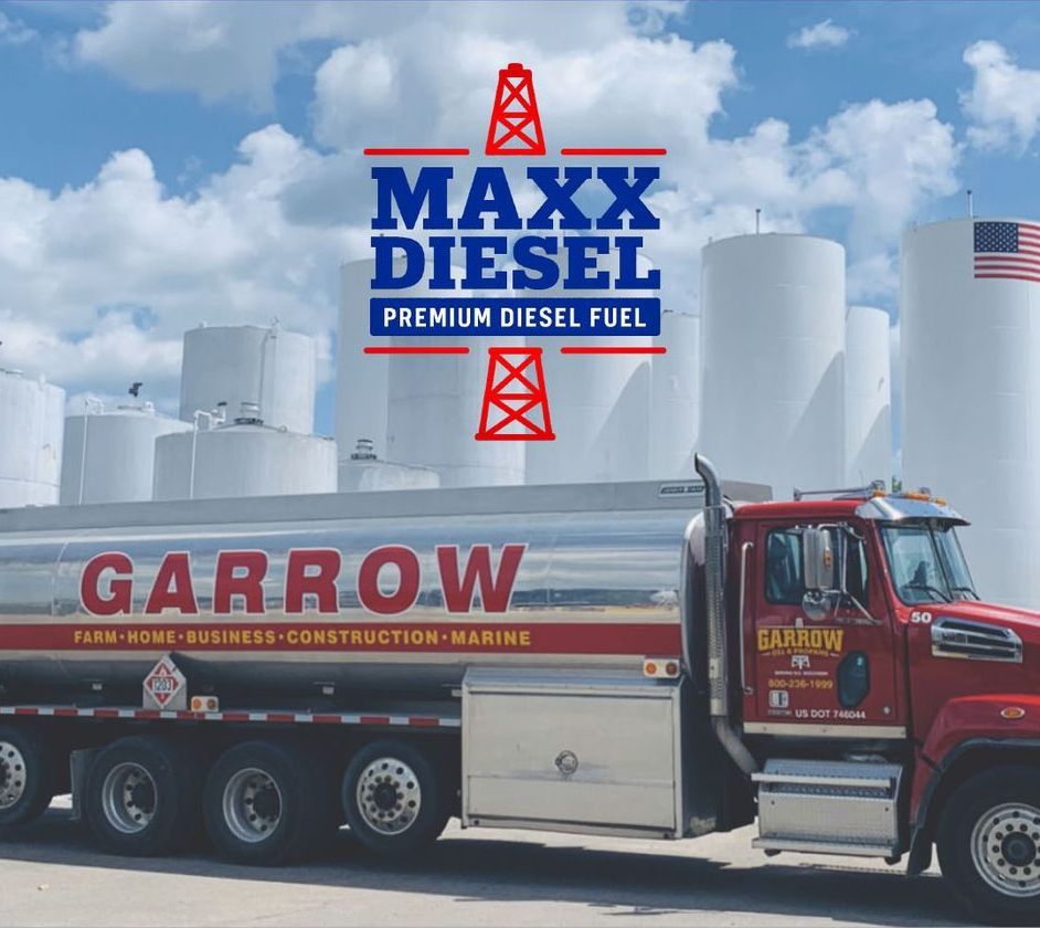 MAXX Diesel logo over Garrow fuel truck, red, silver, and white. Tanks and blue sky in background