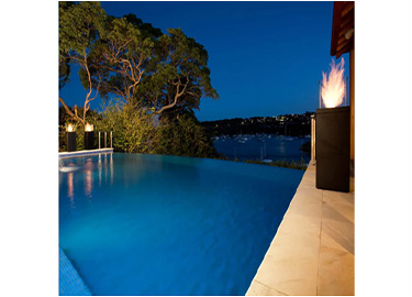 A large swimming pool is lit up at night