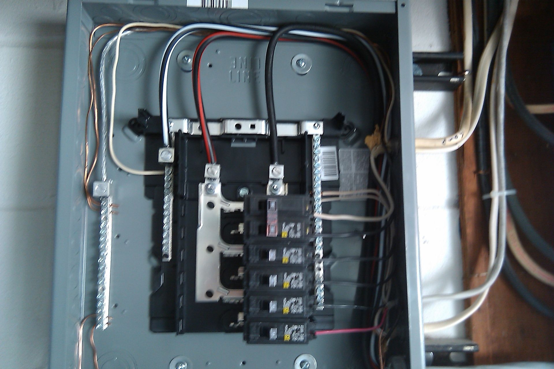 a close up of an electrical box with wires coming out of it