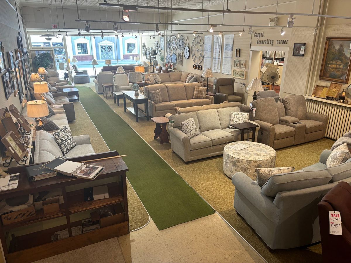 Interior of a furniture store showing many couches, lamps, and decor items in various styles.