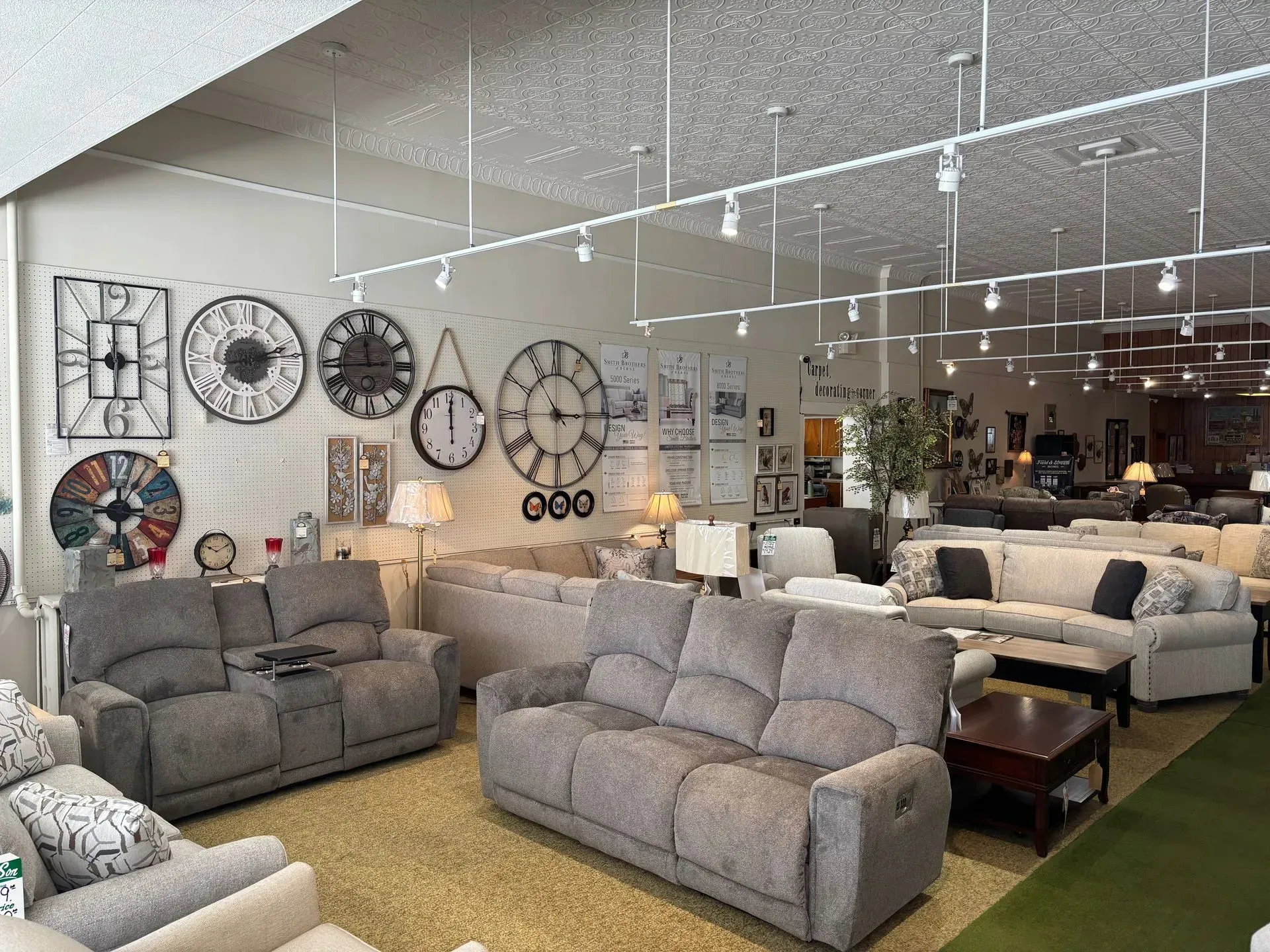 Interior of a furniture store with various sofas, clocks, and lamps on display.