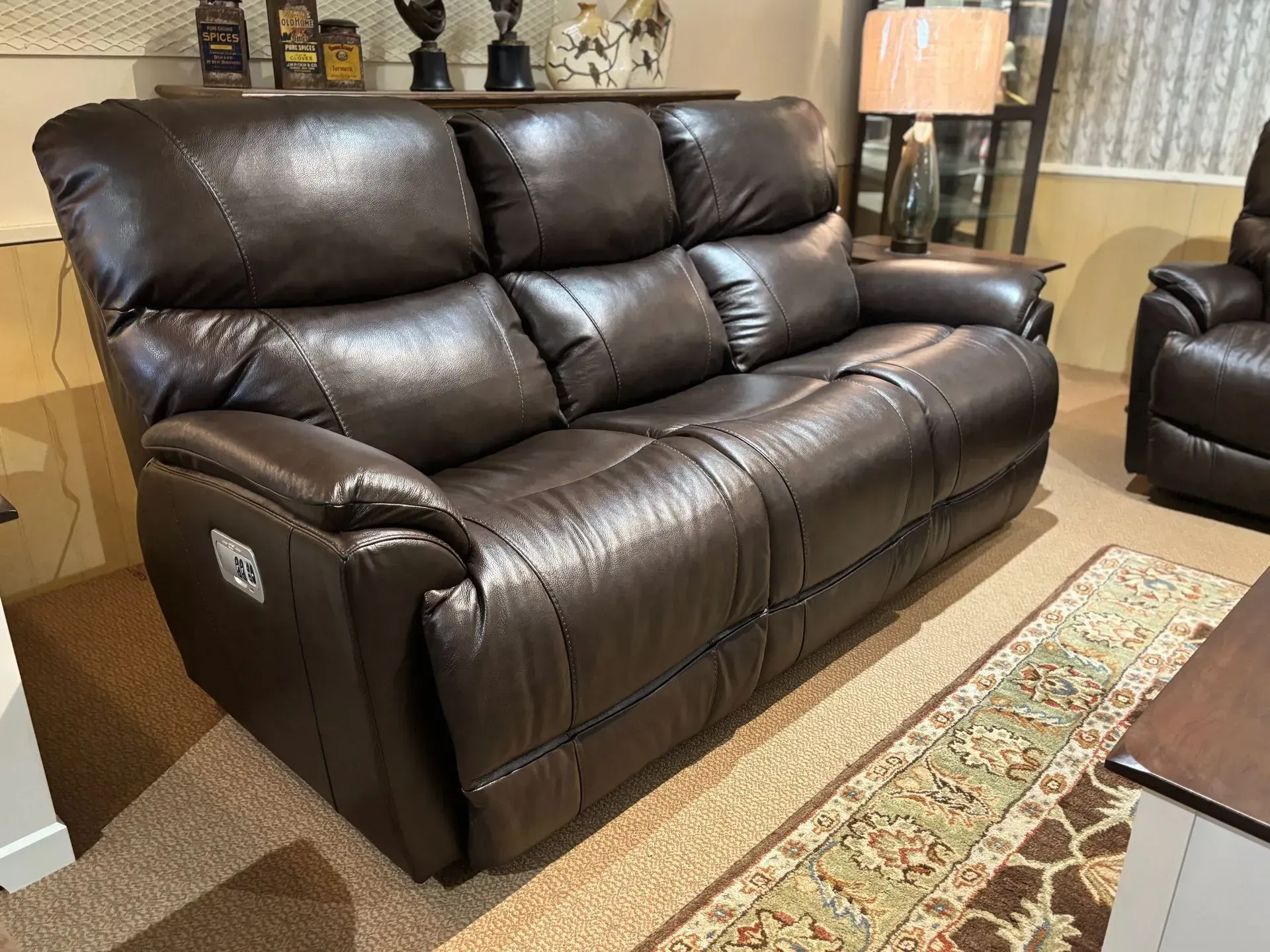 Brown leather reclining sofa in a room.