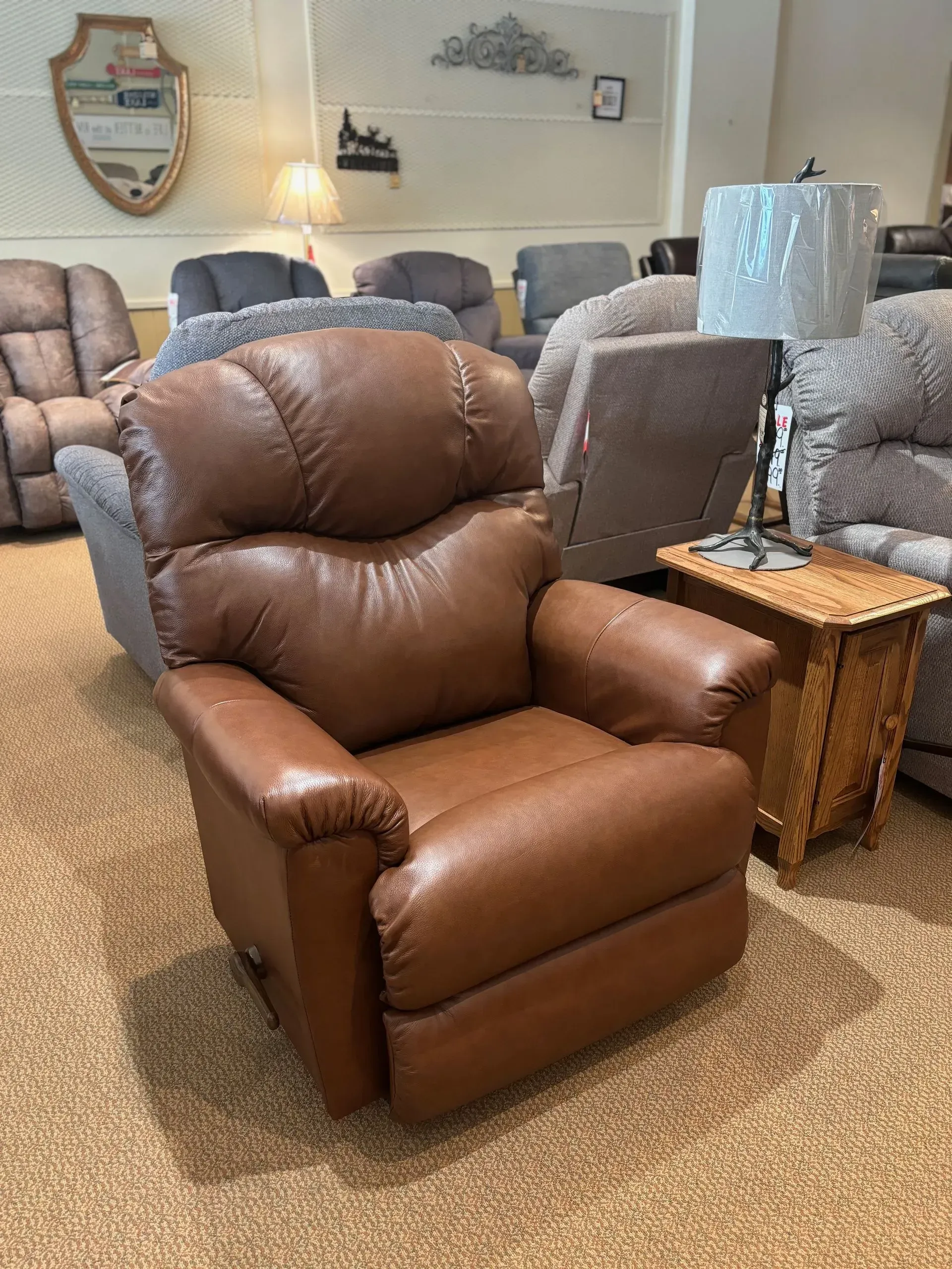 Brown leather recliner chair in a furniture store showroom.