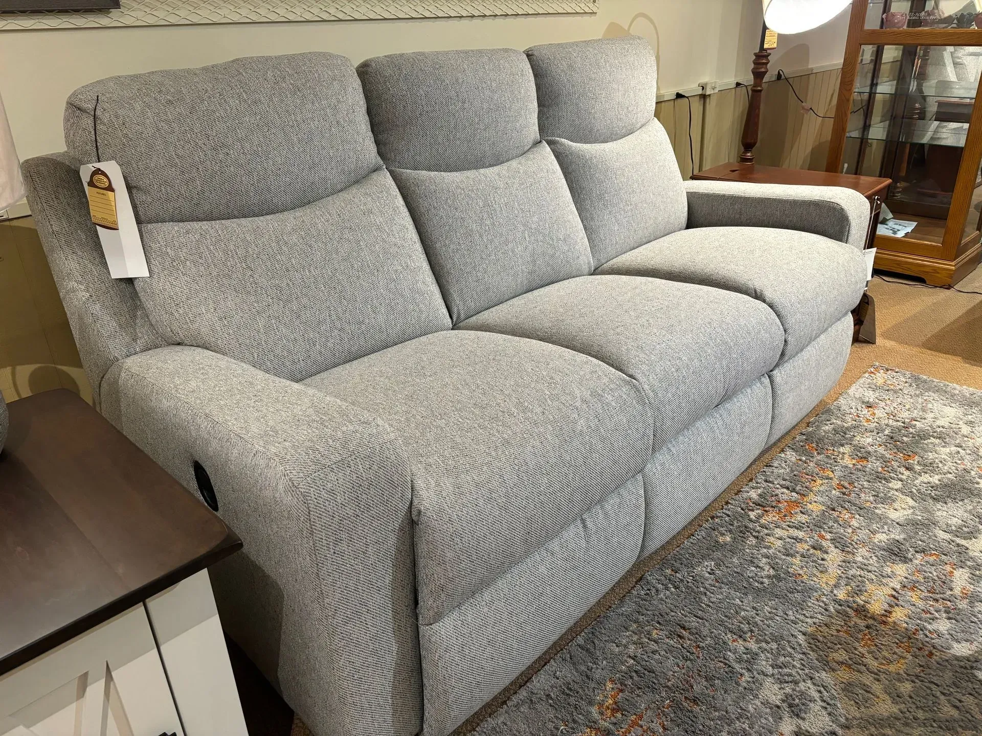 Gray fabric recliner sofa in a furniture store.