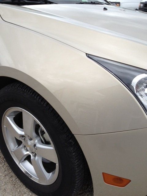 a close up of a car 's wheel and fender